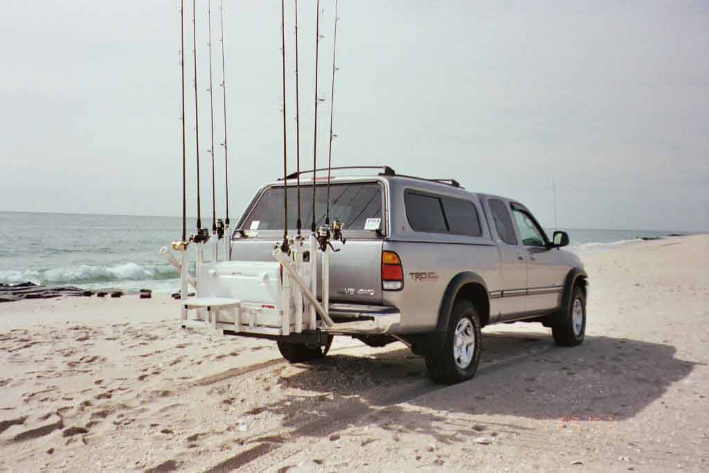 StowAway SwingAway Frame on Toyota truck with custom cargo rack and fishing rod holders
